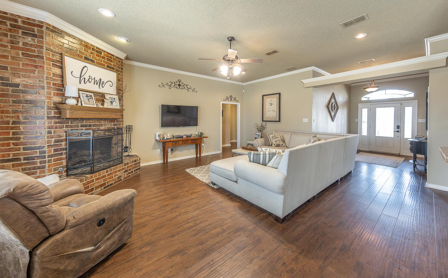 6309 County Road 7470 Lubbock, TX 79424 - Photo 4 of 41 a living room with furniture wooden floor and a fireplace