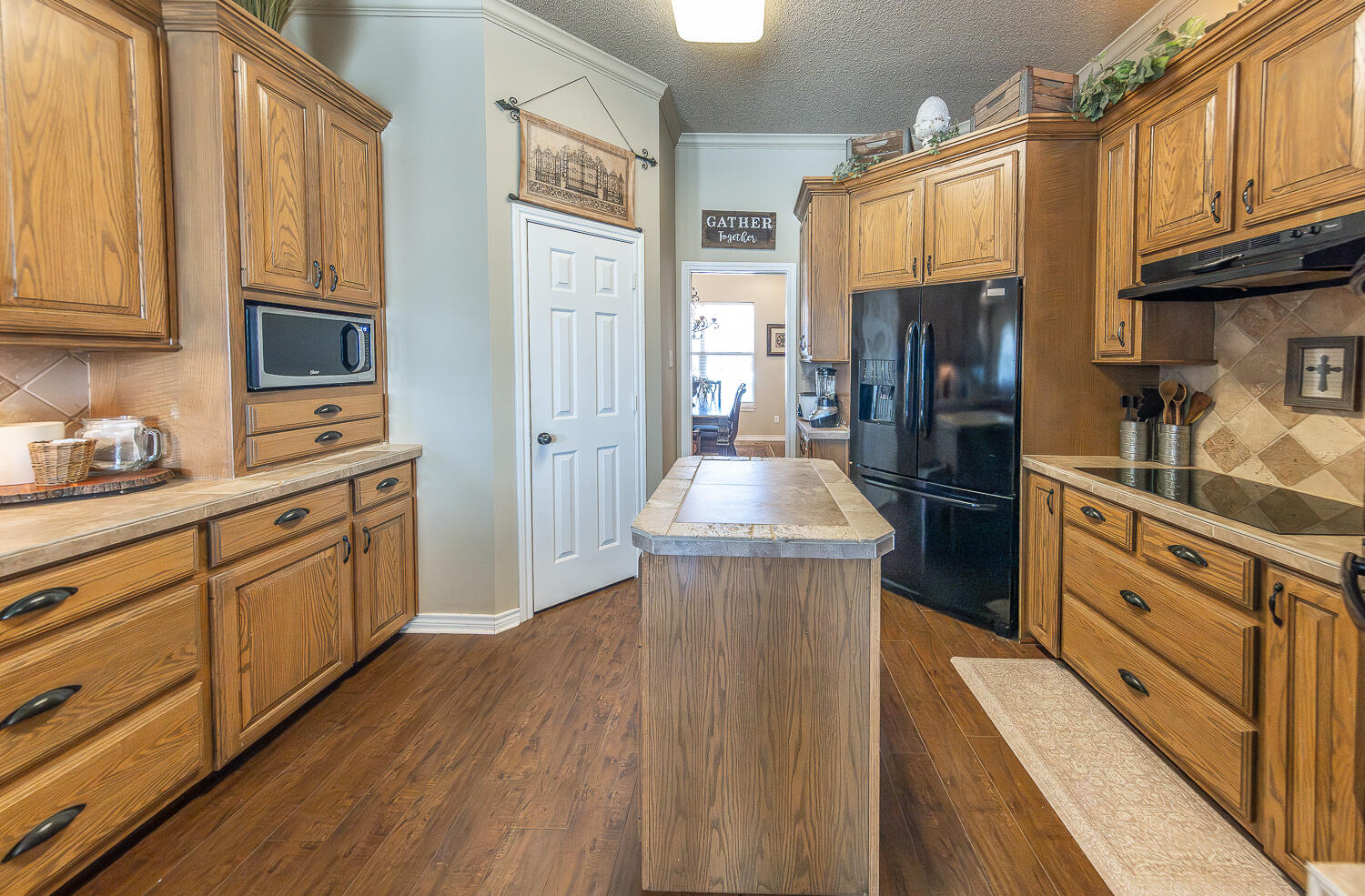 6309 County Road 7470 Lubbock, TX 79424 - Photo 6 of 41 a kitchen with stainless steel appliances granite countertop a refrigerator a stove and a wooden floors