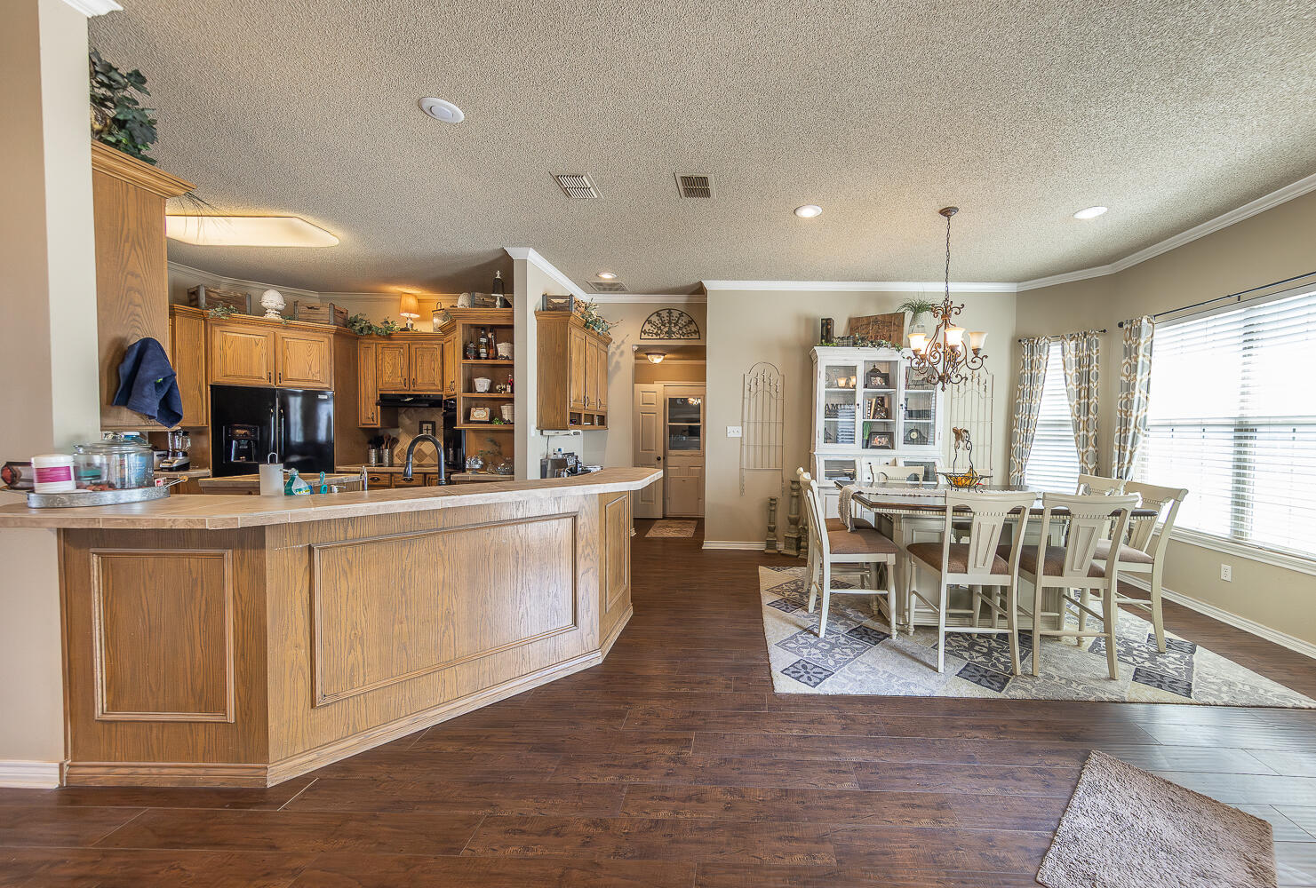 6309 County Road 7470 Lubbock, TX 79424 - Photo 10 of 41 a view of a dining room kitchen with furniture and wooden floor