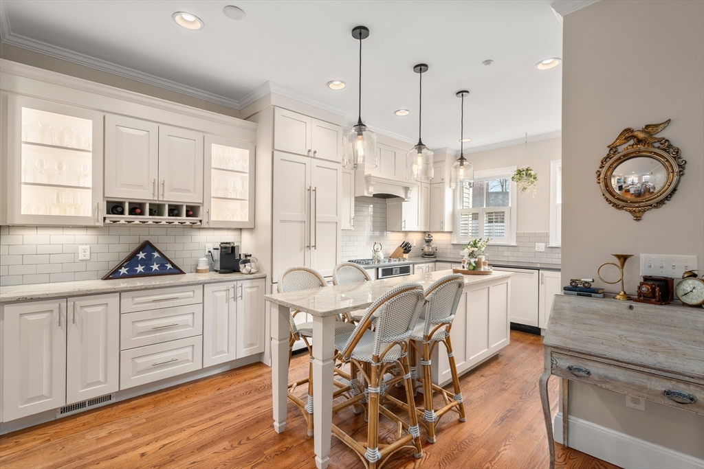 19 Charles Street Boston, MA 02129 - Photo 1 of 28 a kitchen with stainless steel appliances granite countertop a stove a sink dishwasher and white cabinets with wooden floor
