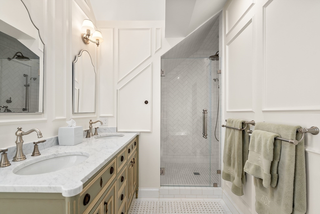 19 Charles Street Boston, MA 02129 - Photo 13 of 28 a bathroom with a granite countertop sink and a mirror