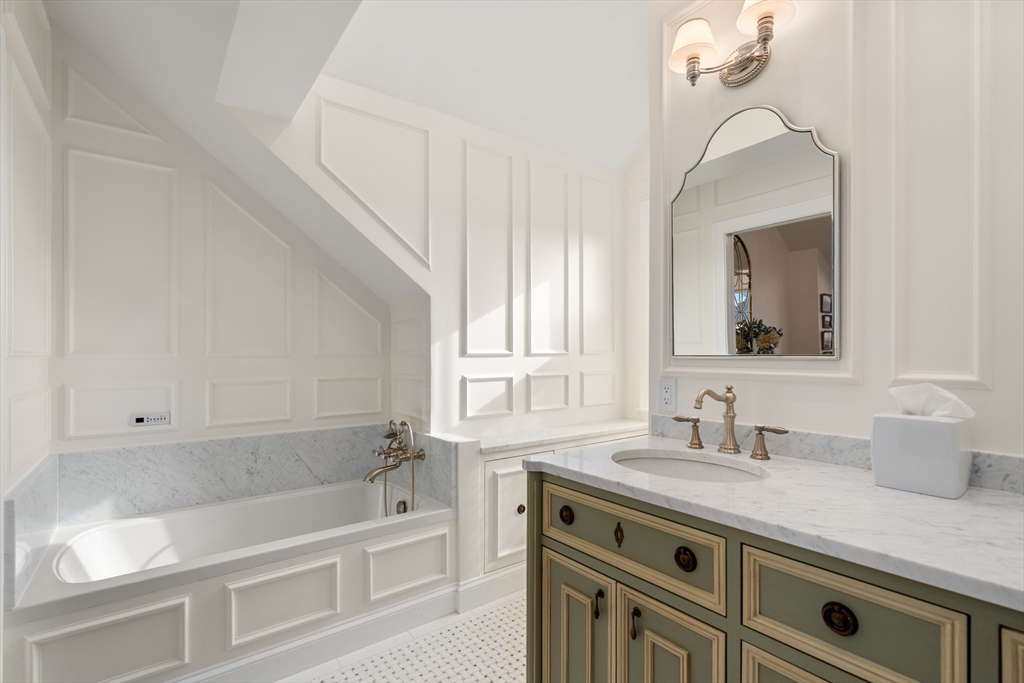 19 Charles Street Boston, MA 02129 - Photo 14 of 28 a bathroom with a tub a sink and mirror