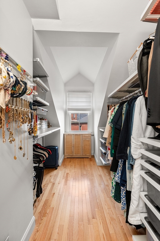 19 Charles Street Boston, MA 02129 - Photo 15 of 28 a view of walk in closet with clothes and shoes