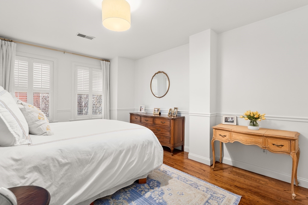 19 Charles Street Boston, MA 02129 - Photo 17 of 28 a bedroom with a bed and a window
