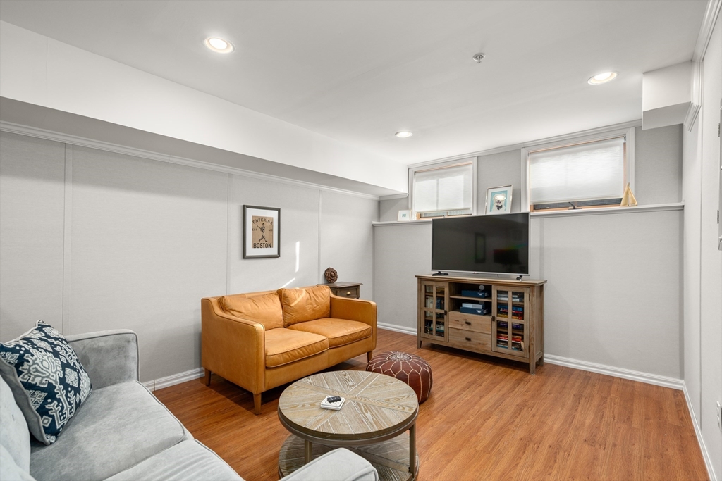 19 Charles Street Boston, MA 02129 - Photo 20 of 28 a living room with furniture and a flat screen tv
