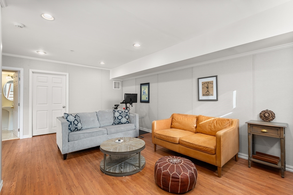 19 Charles Street Boston, MA 02129 - Photo 21 of 28 a living room with furniture and a wooden floor