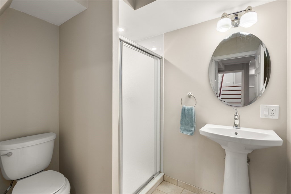 19 Charles Street Boston, MA 02129 - Photo 22 of 28 a bathroom with a toilet sink and mirror