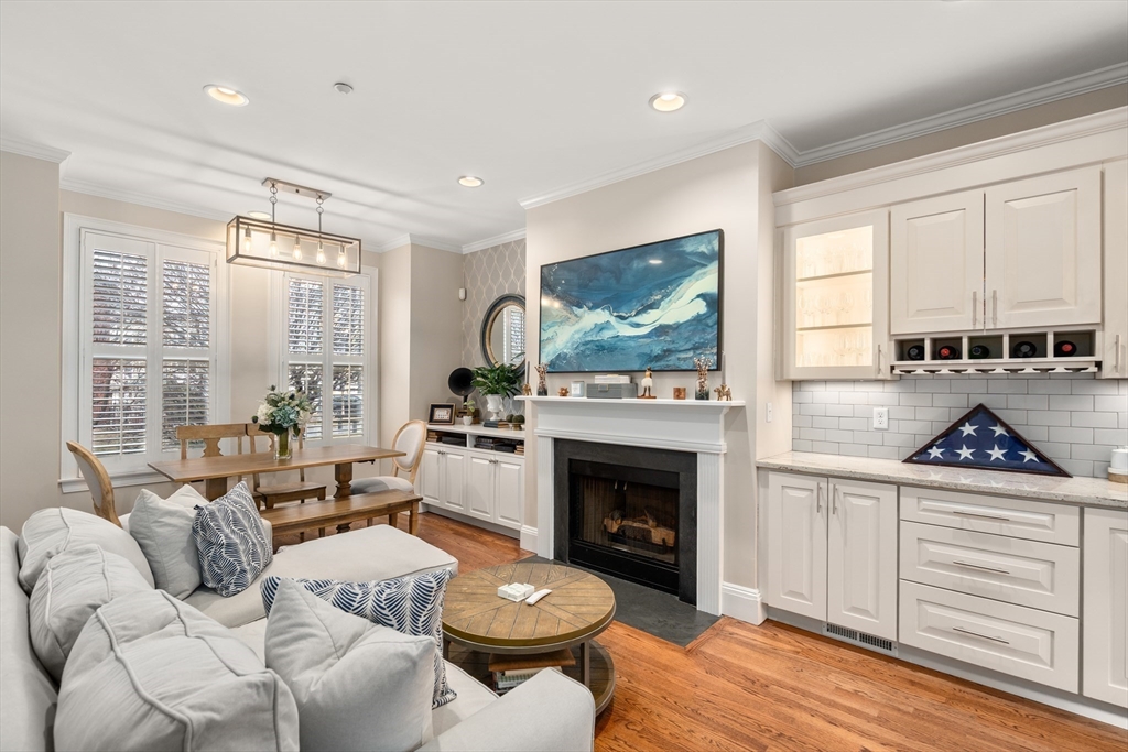 19 Charles Street Boston, MA 02129 - Photo 4 of 28 a living room with furniture a large window and a fireplace