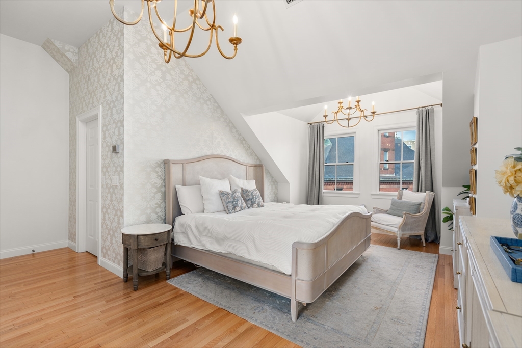 19 Charles Street Boston, MA 02129 - Photo 10 of 28 a bedroom with a bed and window