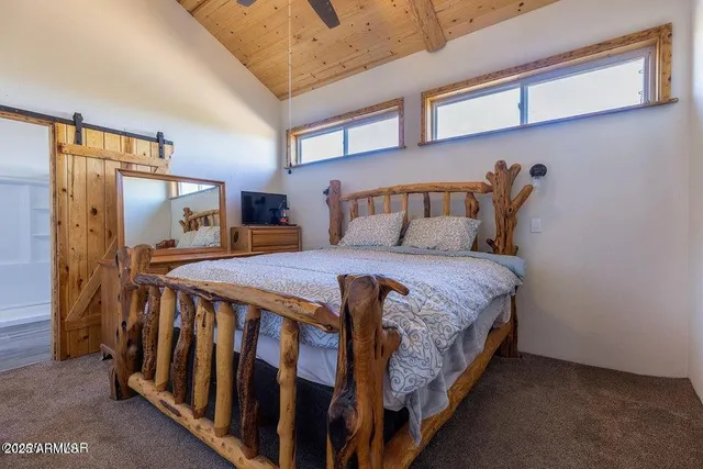 a bedroom with a bed window and a walk in closet