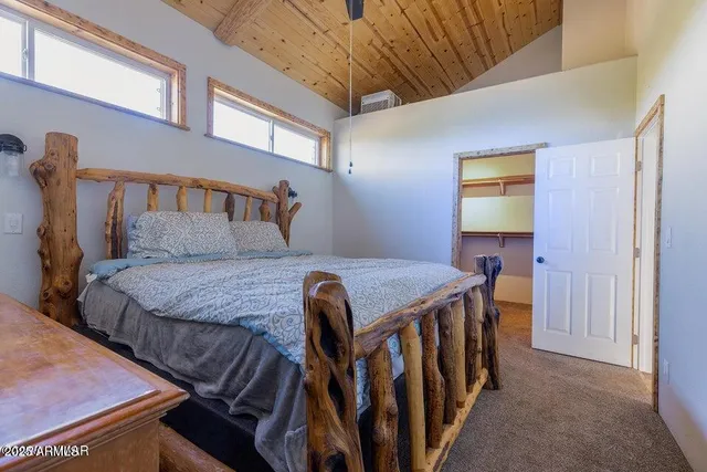 a bedroom with a bed and a table