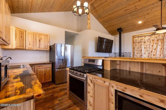 a kitchen with stainless steel appliances a stove microwave and refrigerator