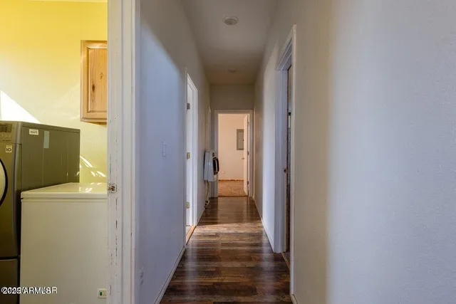 a view of a hallway with wooden floor