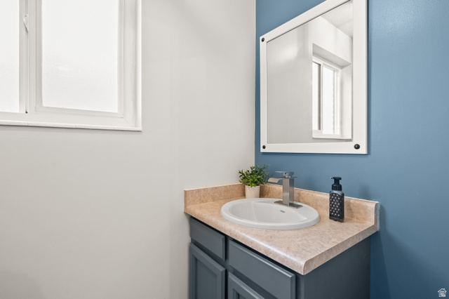 9750 Indian Ridge Drive Sandy, UT 84092 - Photo 38 of 40 Bathroom featuring vanity and plenty of natural light