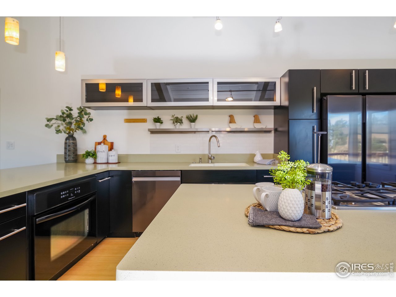 8324 West Fork Road Boulder, CO 80302 - Photo 11 of 38 a kitchen with a sink and dishwasher a kitchen island with wooden floor