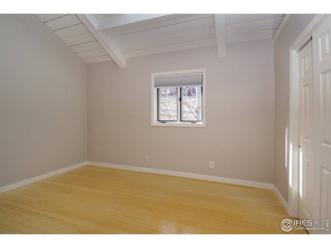 8324 West Fork Road Boulder, CO 80302 - Photo 19 of 38 a view of an empty room with wooden floor and a window