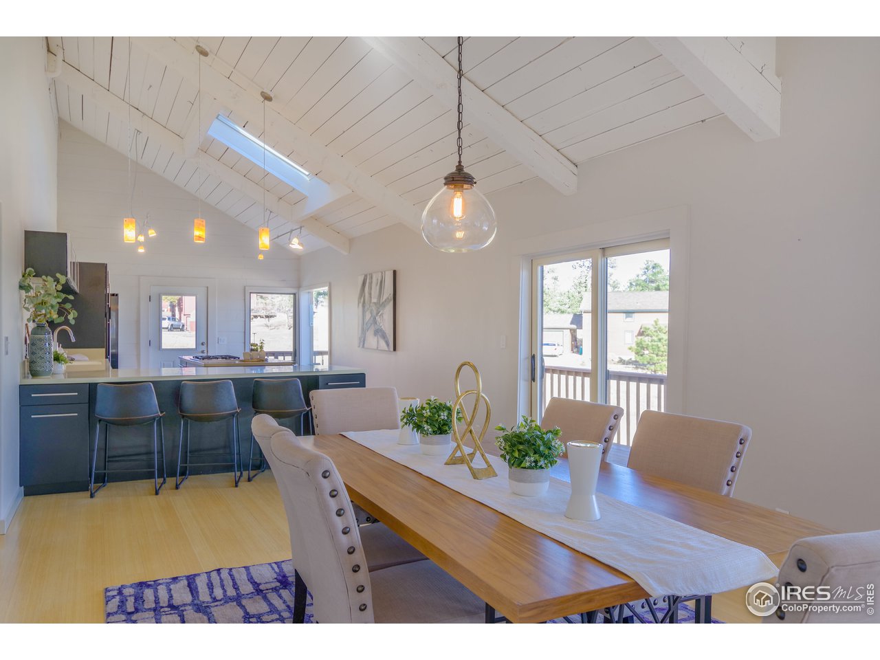 8324 West Fork Road Boulder, CO 80302 - Photo 8 of 38 a view of a dining room and livingroom with furniture wooden floor a rug and a chandelier