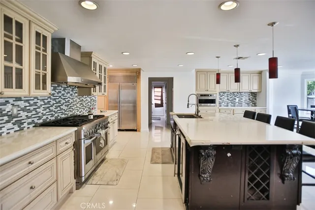 a large kitchen with stainless steel appliances kitchen island granite countertop a sink and cabinets