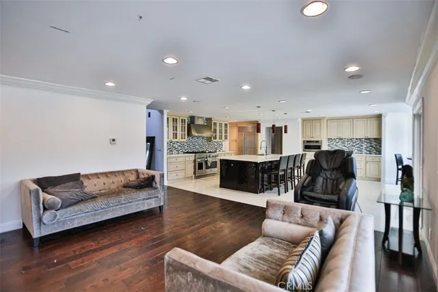 a living room with furniture and kitchen view