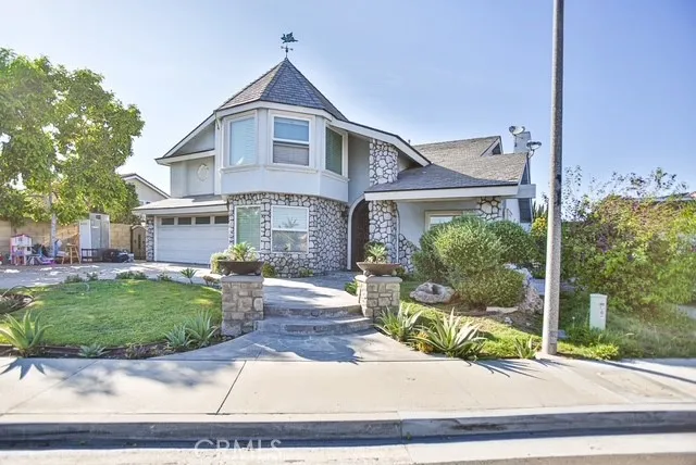 a front view of a house with a yard and green space