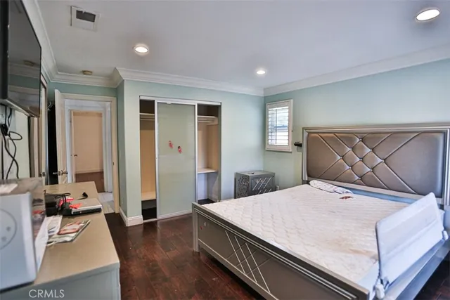 a bedroom with a bed and flat screen tv