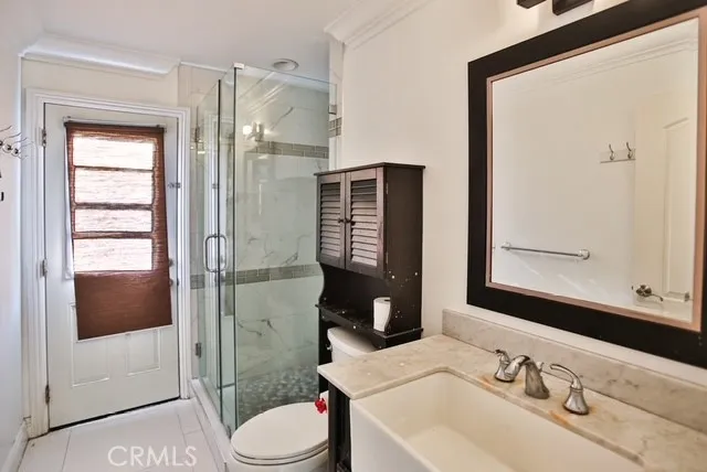 a bathroom with a sink vanity granite tub and shower