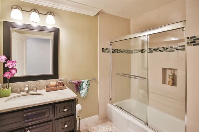 a bathroom with a bathtub sink and mirror