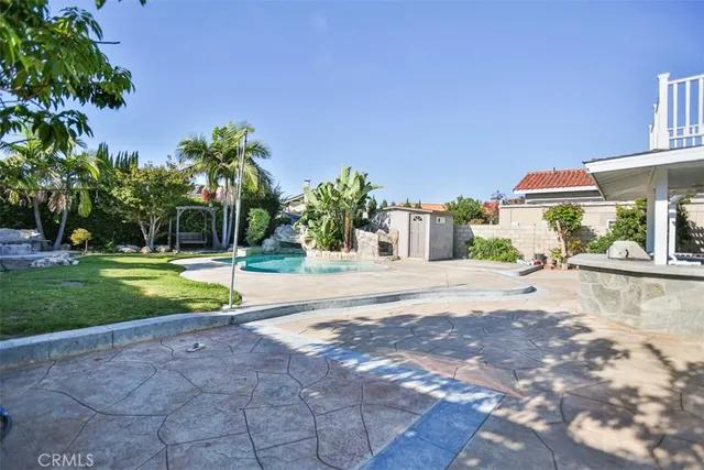 a view of a house with swimming pool and sitting area
