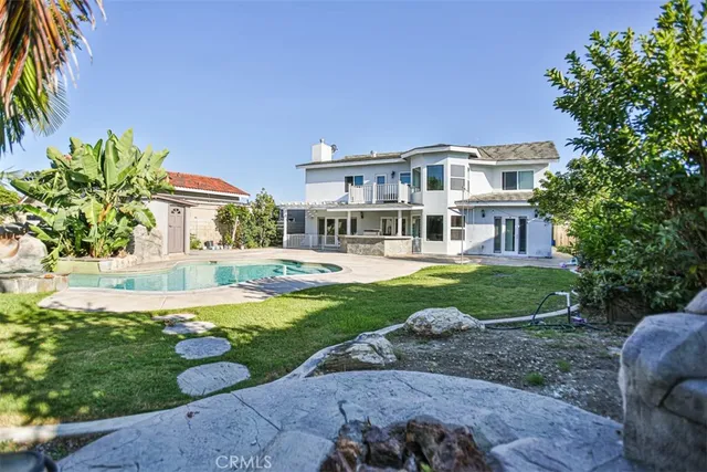 a front view of a house with swimming pool having outdoor seating