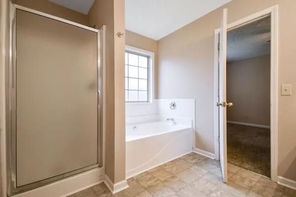a bathroom with a bathtub and a shower