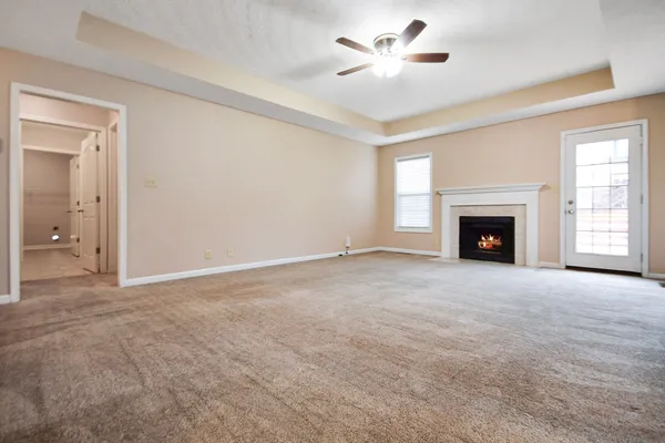 a view of empty room with a fireplace