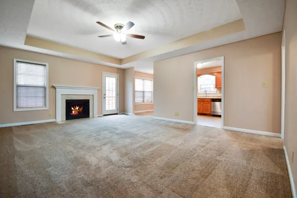 a view of empty room with a fireplace