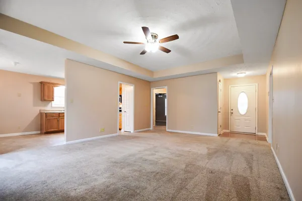 a view of a livingroom with a ceiling fan and window