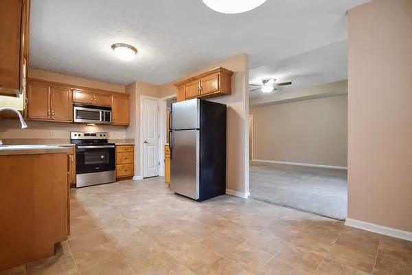 a kitchen with a refrigerator and a microwave