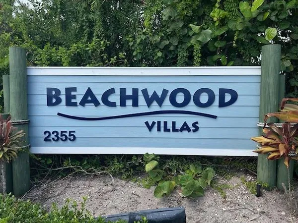 a sign broad in front of flowers