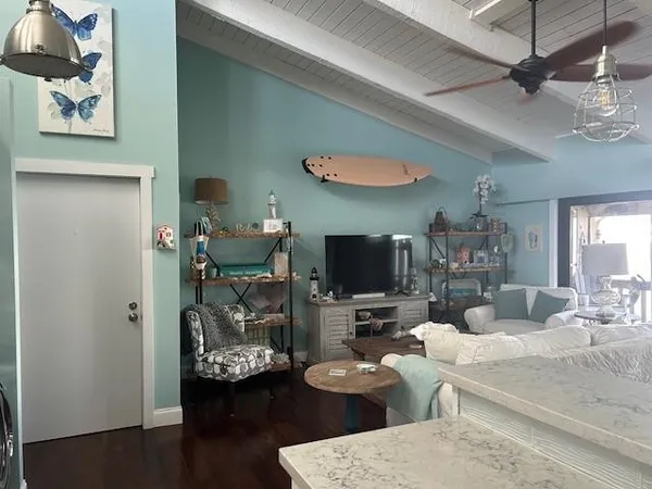 a living room with furniture a flat screen tv and a wall