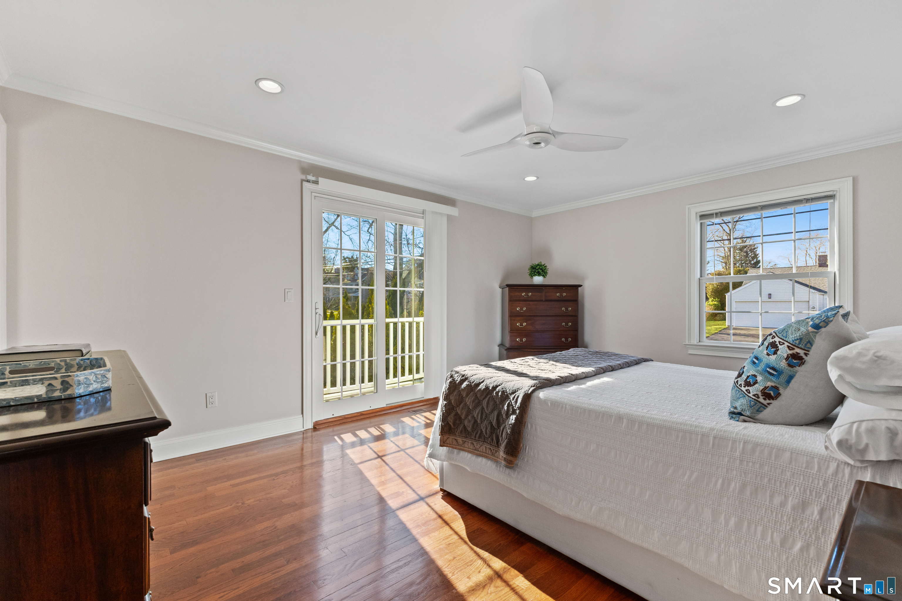 61 Hobson Street Stamford, CT 06902 - Photo 17 of 36 a bedroom with a bed and wooden floor