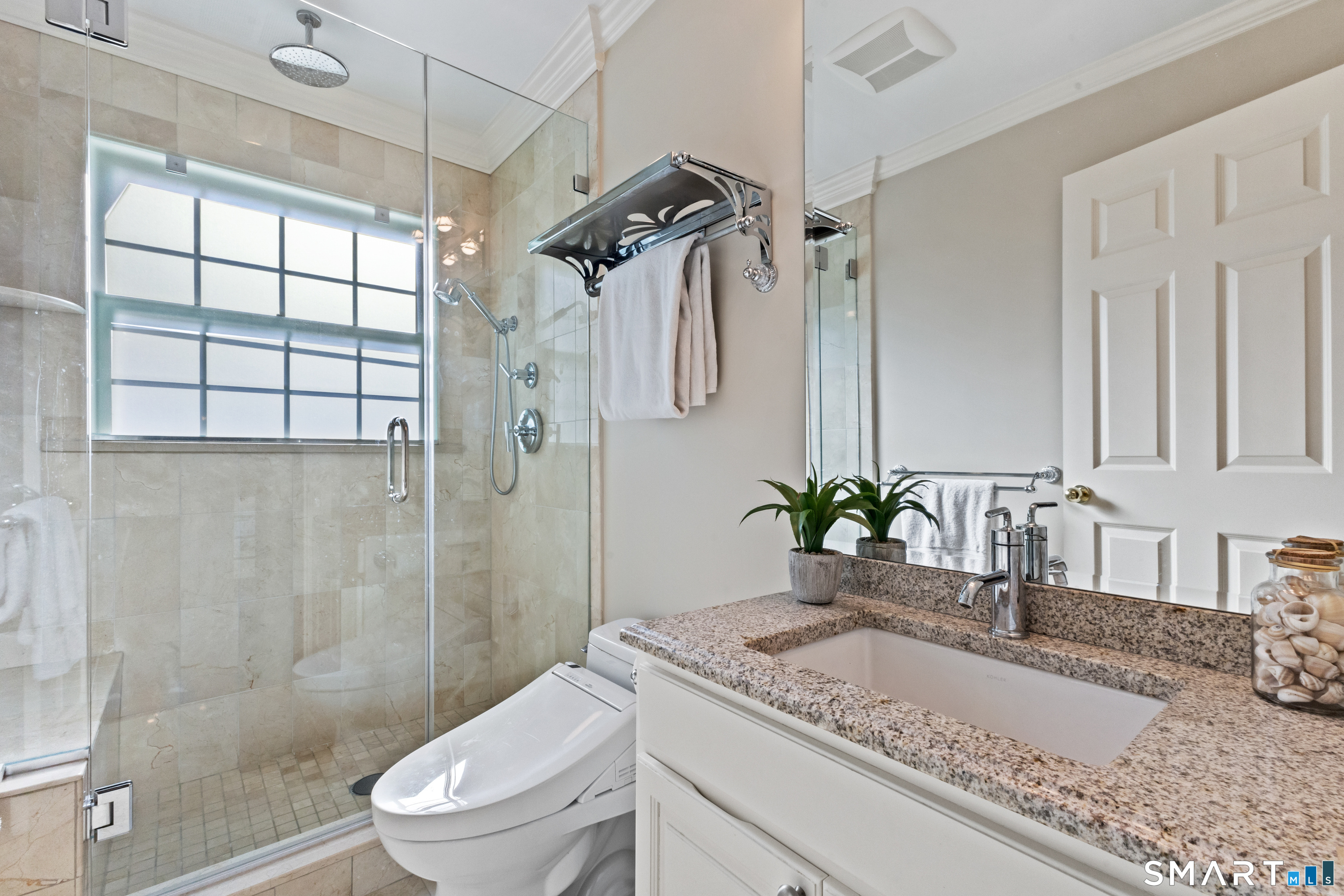61 Hobson Street Stamford, CT 06902 - Photo 20 of 36 a bathroom with a granite countertop sink a toilet and shower