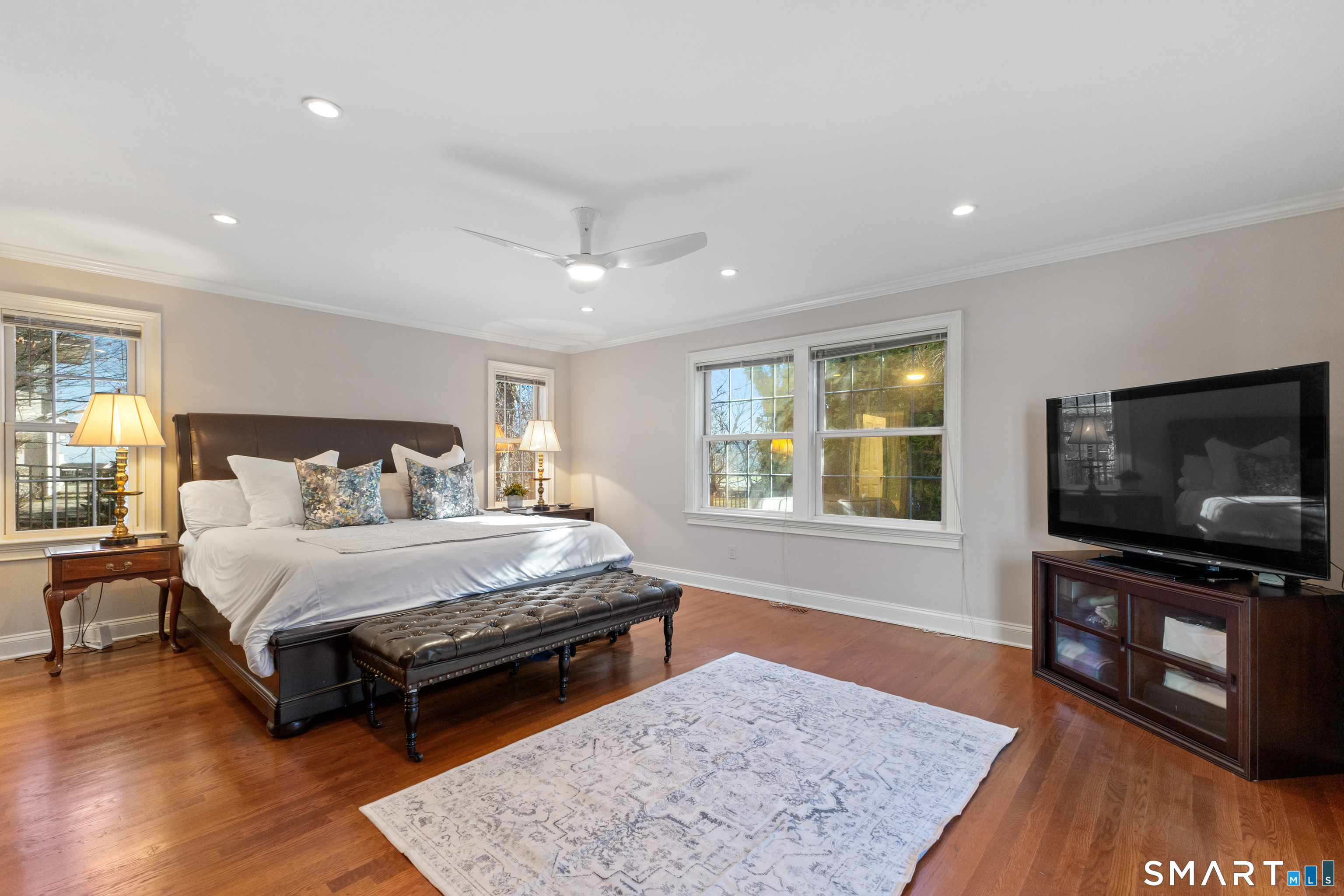 61 Hobson Street Stamford, CT 06902 - Photo 23 of 36 a spacious bedroom with a bed and a flat screen television