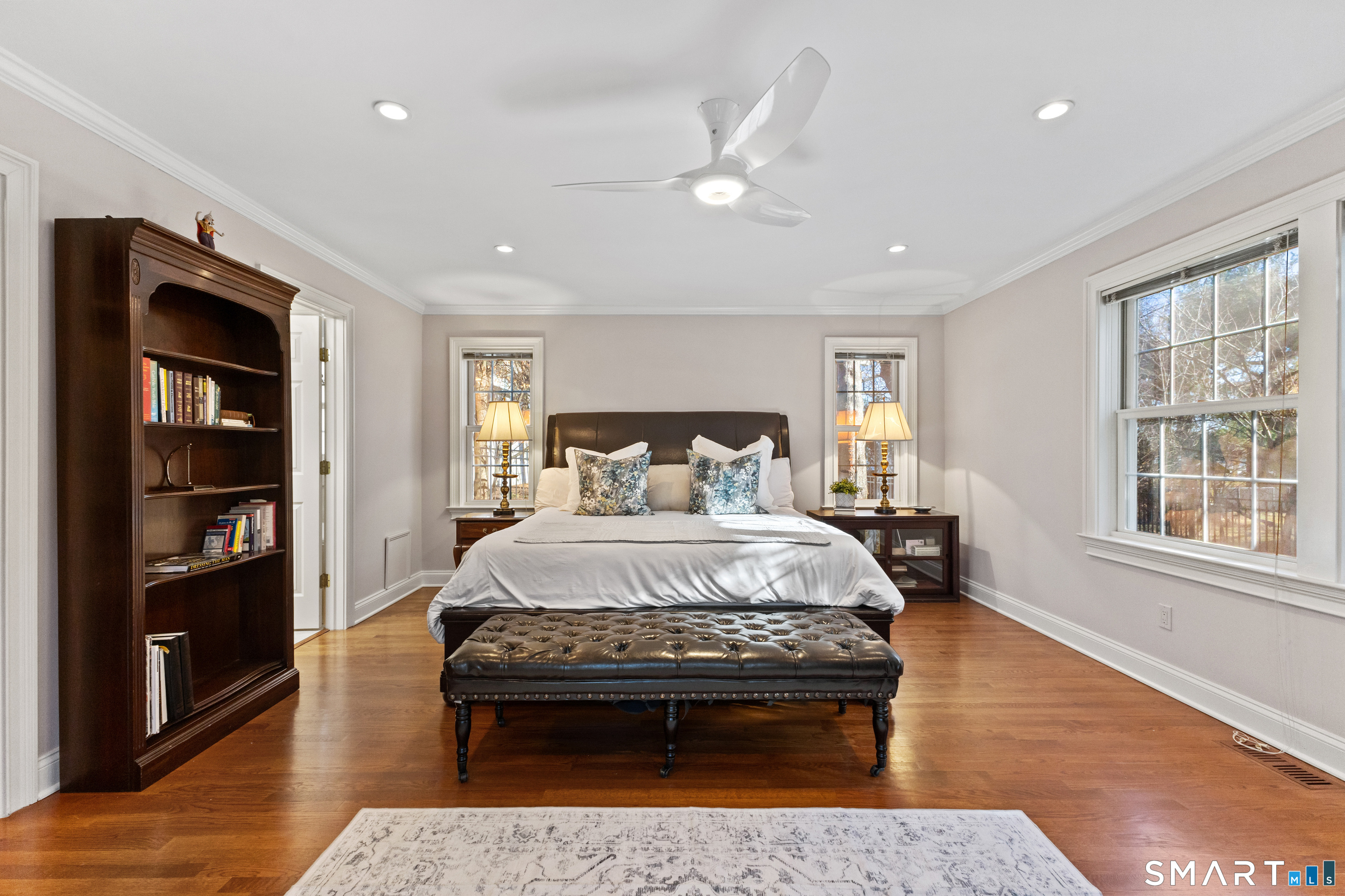 61 Hobson Street Stamford, CT 06902 - Photo 24 of 36 a bedroom with a bed and wooden floor