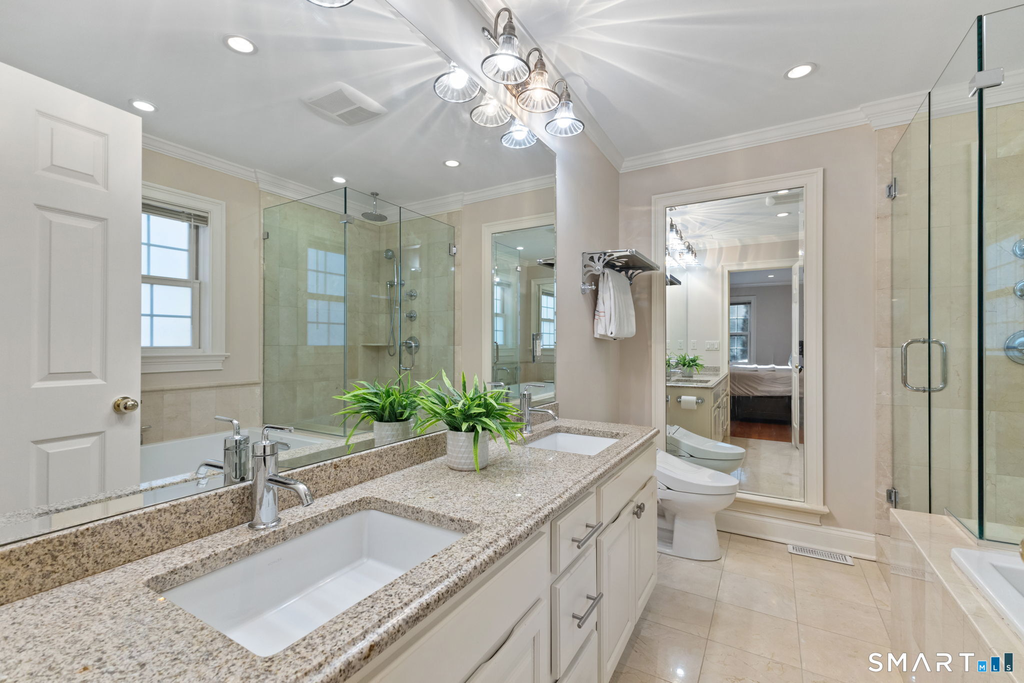 61 Hobson Street Stamford, CT 06902 - Photo 25 of 36 a spacious bathroom with a granite countertop sink mirror and a shower