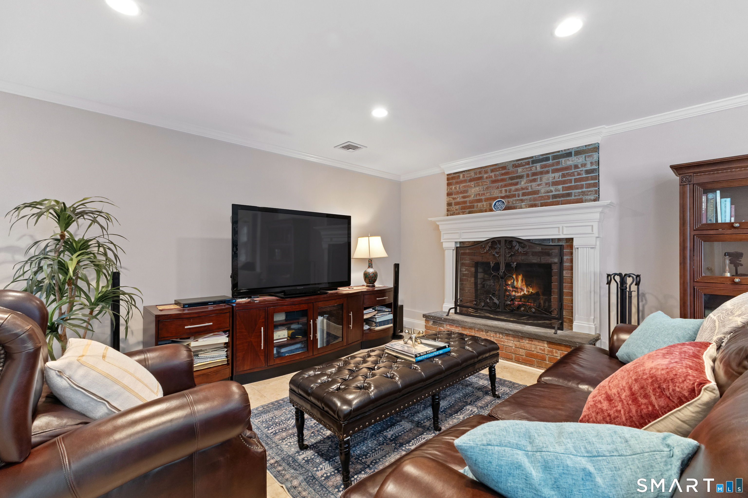 61 Hobson Street Stamford, CT 06902 - Photo 27 of 36 a living room with furniture and a fireplace