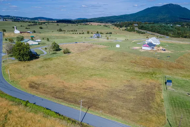 a view of a pool with a table and chairs