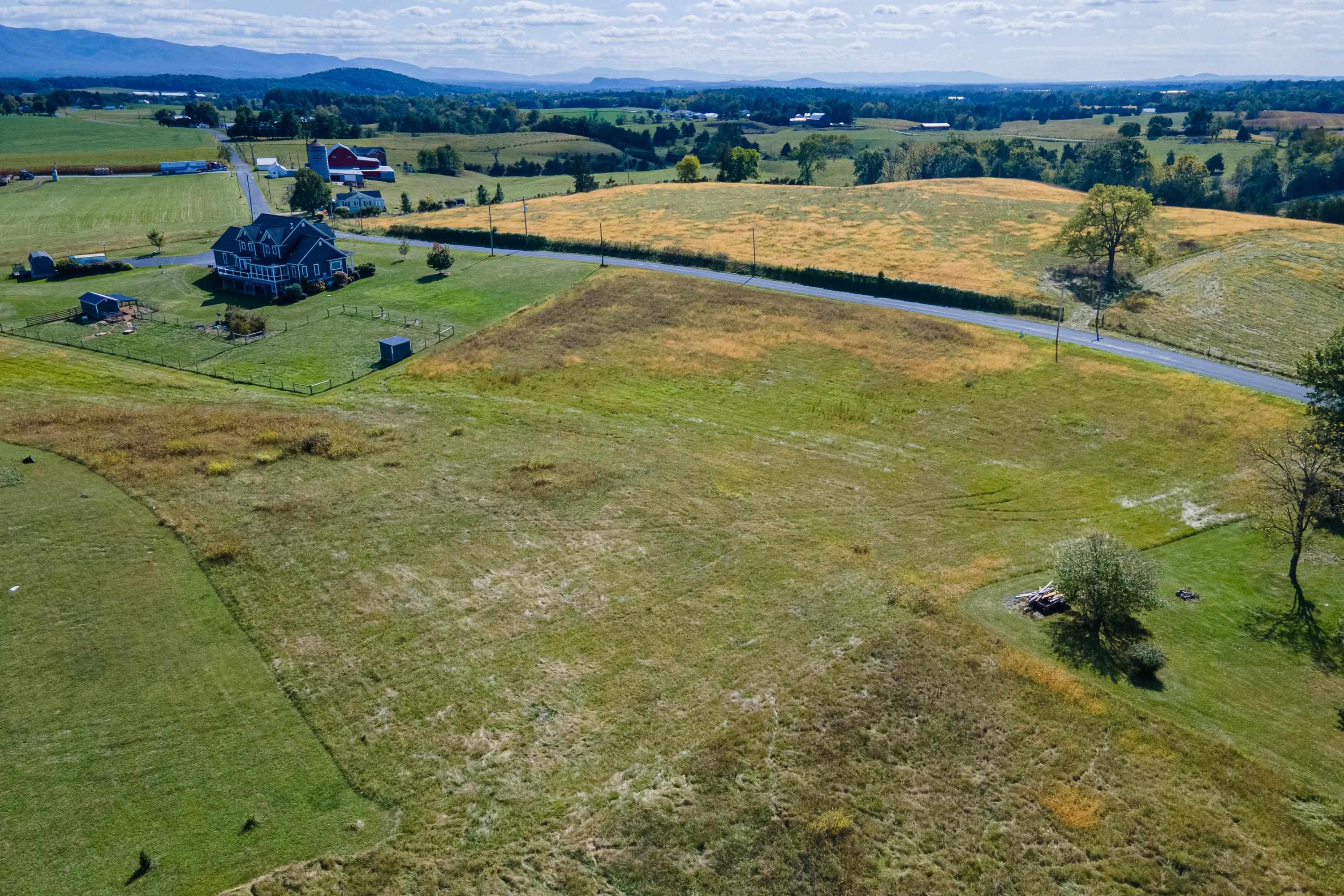 6165 Oak Shade Road Penn Laird, VA 22846 - Photo 15 of 20 a view of a lake with a yard and mountain view