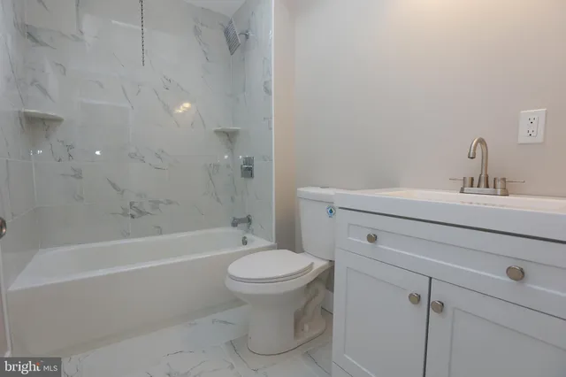 a bathroom with a sink toilet and bathtub