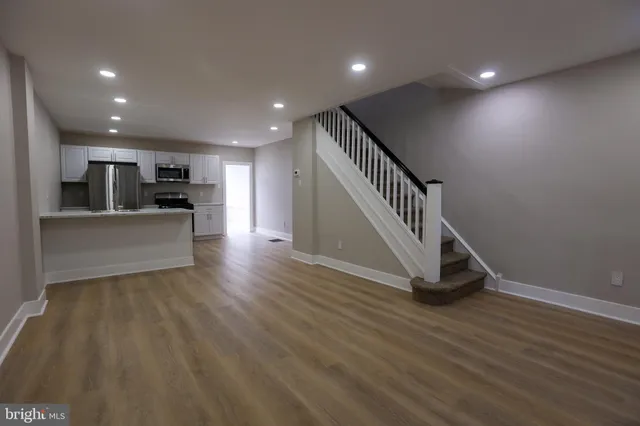 a view of a kitchen with a sink and a refrigerator