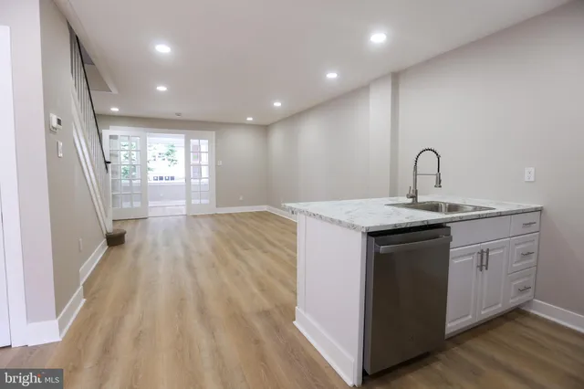 a kitchen with sink a vanity and appliances
