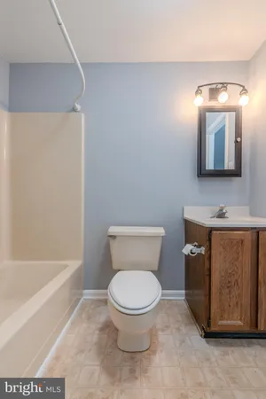 a bathroom with a toilet a sink and bathtub