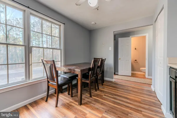 a view of a dining room with furniture and wooden floor