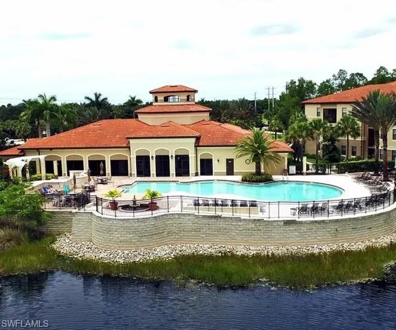 a front view of a house with a yard with swimming pool